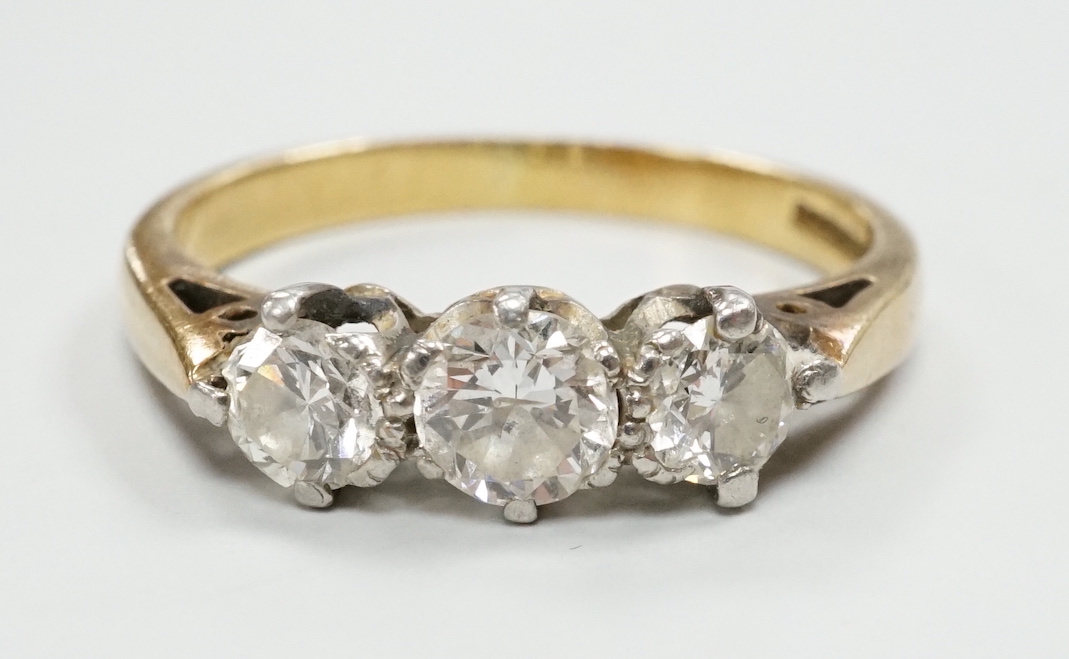 A modern 18ct gold and three stone diamond set ring, size K/L, gross weight 3.6 grams.
